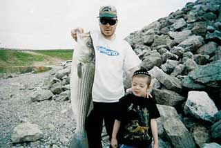 Father and son with a nice striper bass