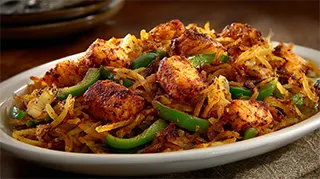 photo of bass hash made with shredded hash browns, green peppers and onions