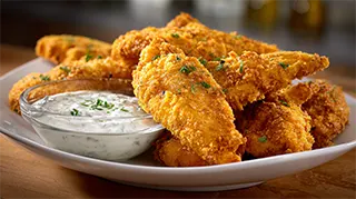 photo of cajun fried bass fillets fried in a bisquick/cornmeal mixture and served with ranch dressing on the side