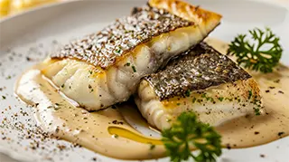 photo of french style broiled striped bass with creamy wine sauce