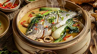 photo of a sea bass steamed with lemon grass and chili broth