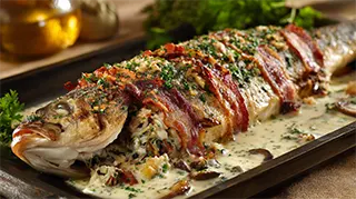 photo of a stuffed baked bass in mushroom sauce